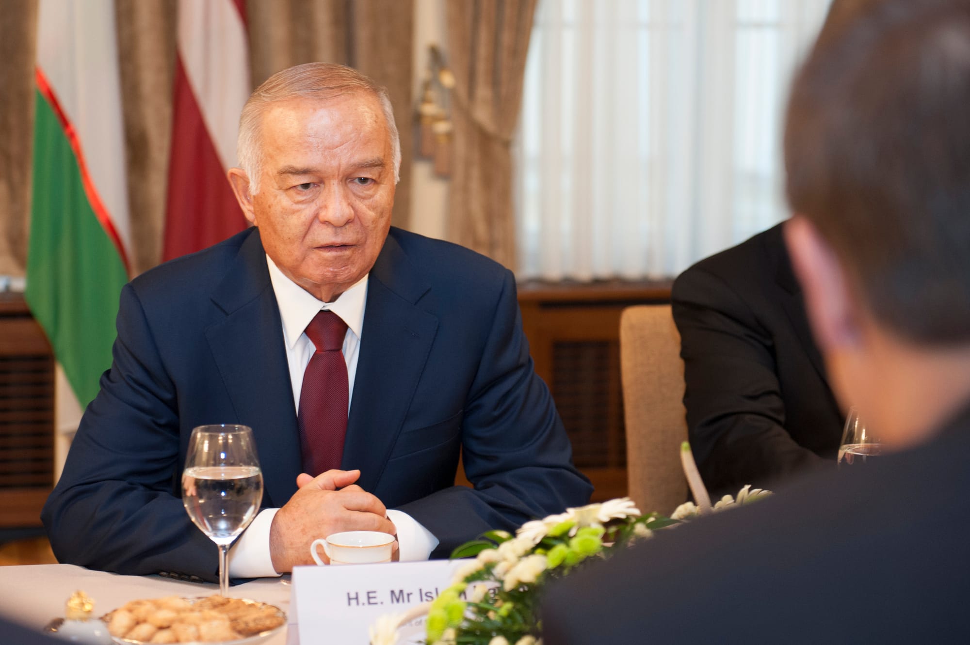Islam Karimov sitting at a banquet table